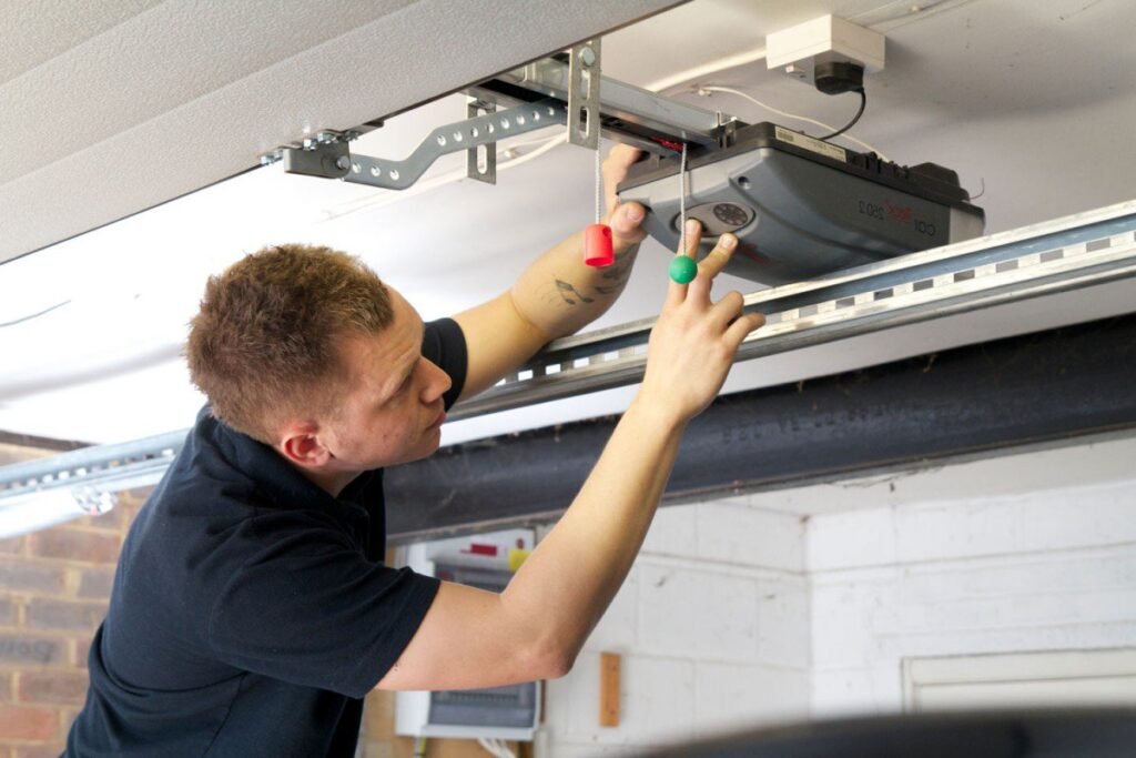 A man is working in garage for some technical work showing Garage door repair near me & Emergency garage door repair Castle Pines